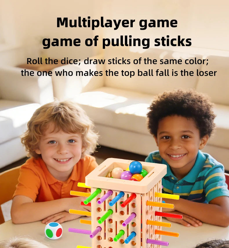 Two smiling boys play a family pick-up sticks game with colored sticks and balls on a wooden board.
