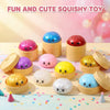 A collection of colorful squishy toys in pink, purple, blue, and yellow housed in small containers.