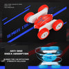 A red and white remote control stunt car with large rubber tires demonstrating anti-skid shock absorption features.