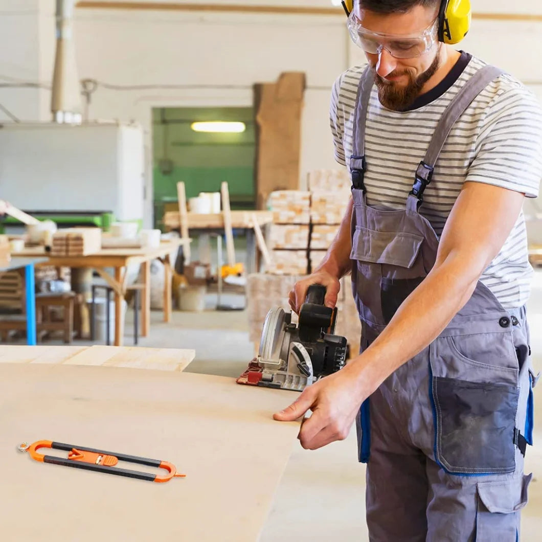 A man wearing safety glasses and an apron uses a contour gauge scribe tool on a piece of wood in a workshop setting.