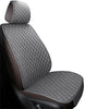 A close-up view of a dark gray quilted car seat cover set with brown accents.