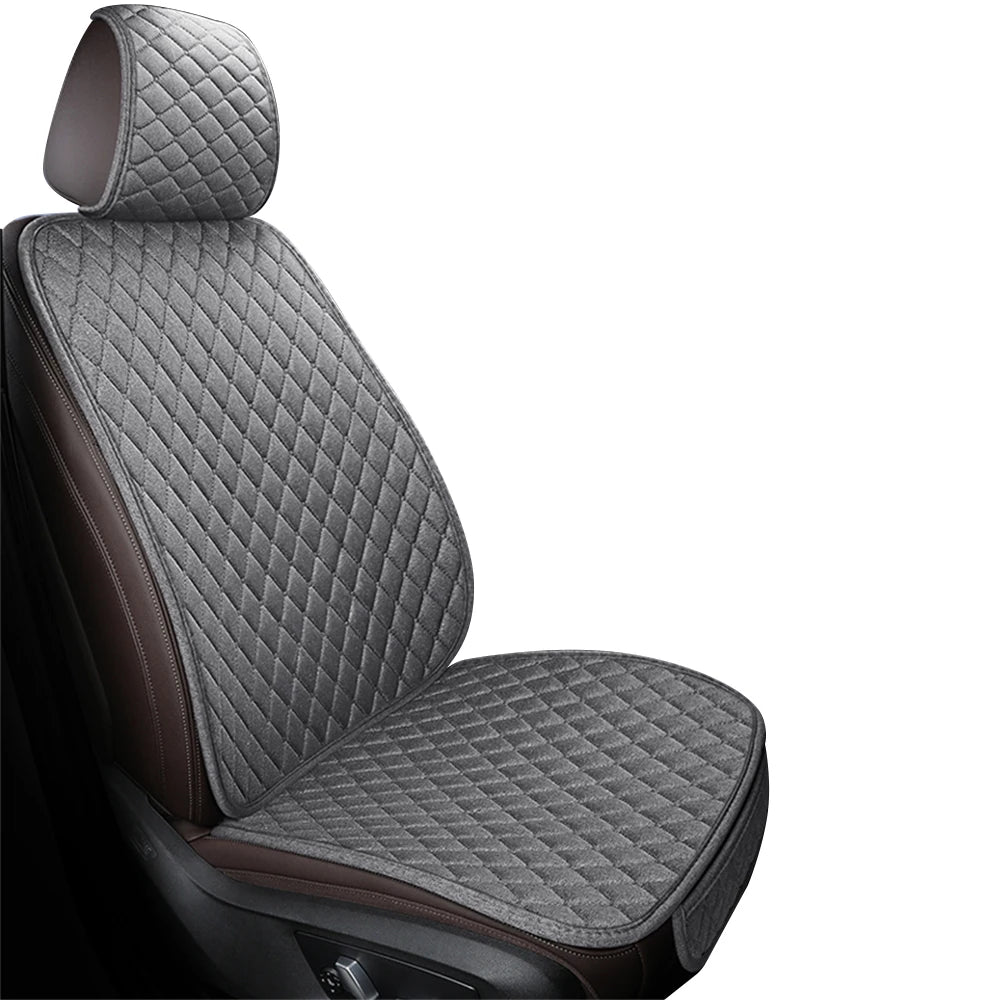 A close-up view of a dark gray quilted car seat cover set with brown accents.
