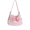 A pink nylon messenger bag with a light pink fabric pouch and a fluffy pink pom-pom charm.