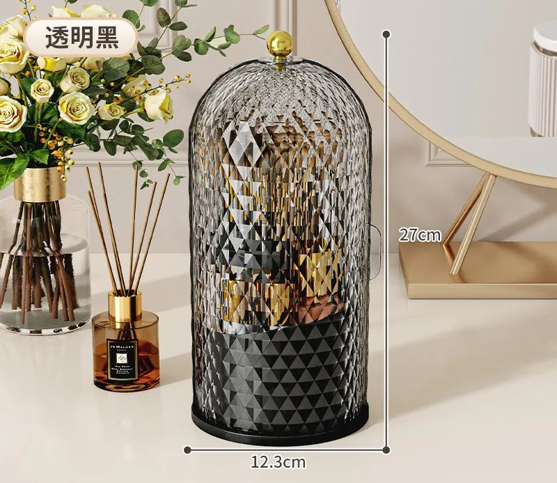 Organizador de vidrio negro para brochas de maquillaje con tapa dorada y patrón geométrico decorativo.