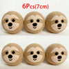 Six natural wool dryer balls shaped like faces are displayed on a white background.