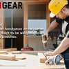 A man wearing a yellow hard hat is using a tool pouch on his belt while working with wood.