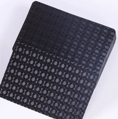 A black playing card deck with a subtle geometric pattern and a matte finish.