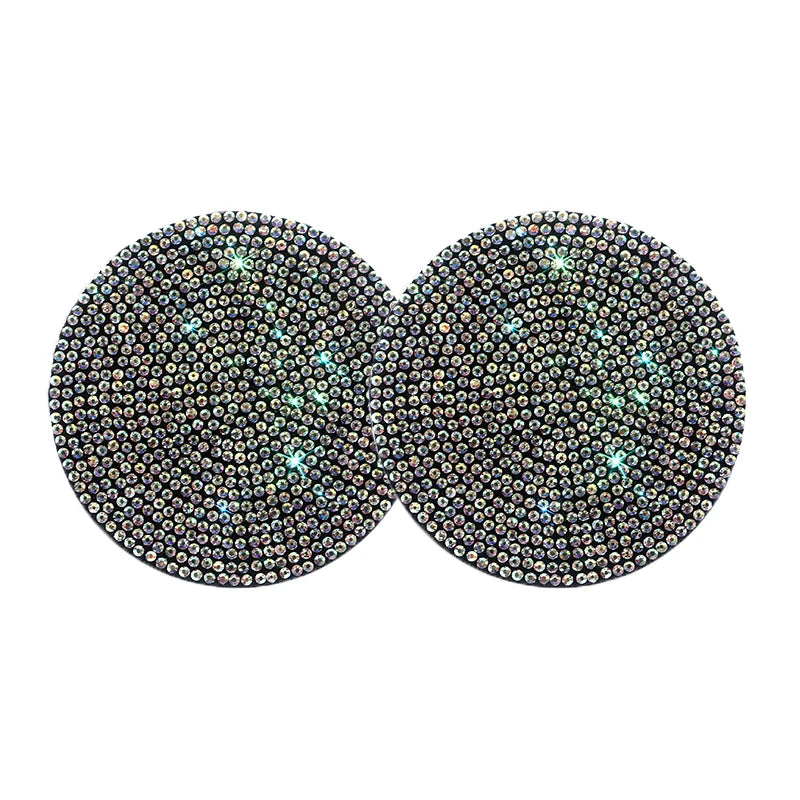 A set of two round, sparkling diamond-encrusted non-slip coasters.