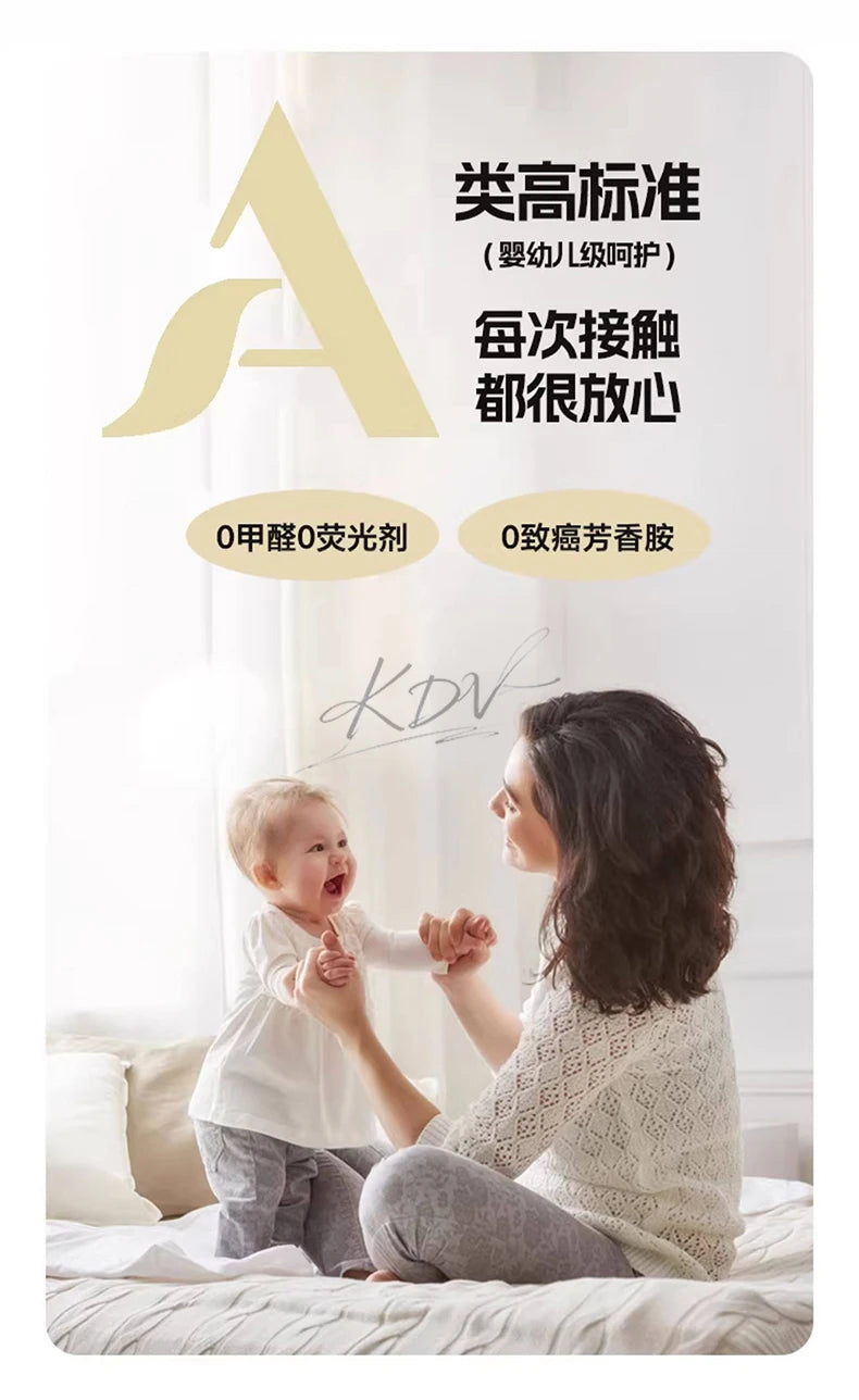 A woman is gently holding a baby while sitting on a bed, suggesting a peaceful and nurturing moment.