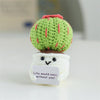 Handmade crochet positive energy doll shaped like a green cactus with a smiling face