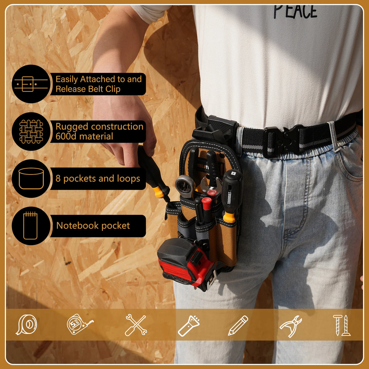 A person is wearing a gray shirt and jeans, holding a black tool pouch with an attached belt clip and various pockets.