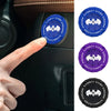 A hand presses a blue push start button cover with a supercar spin design on a car panel.