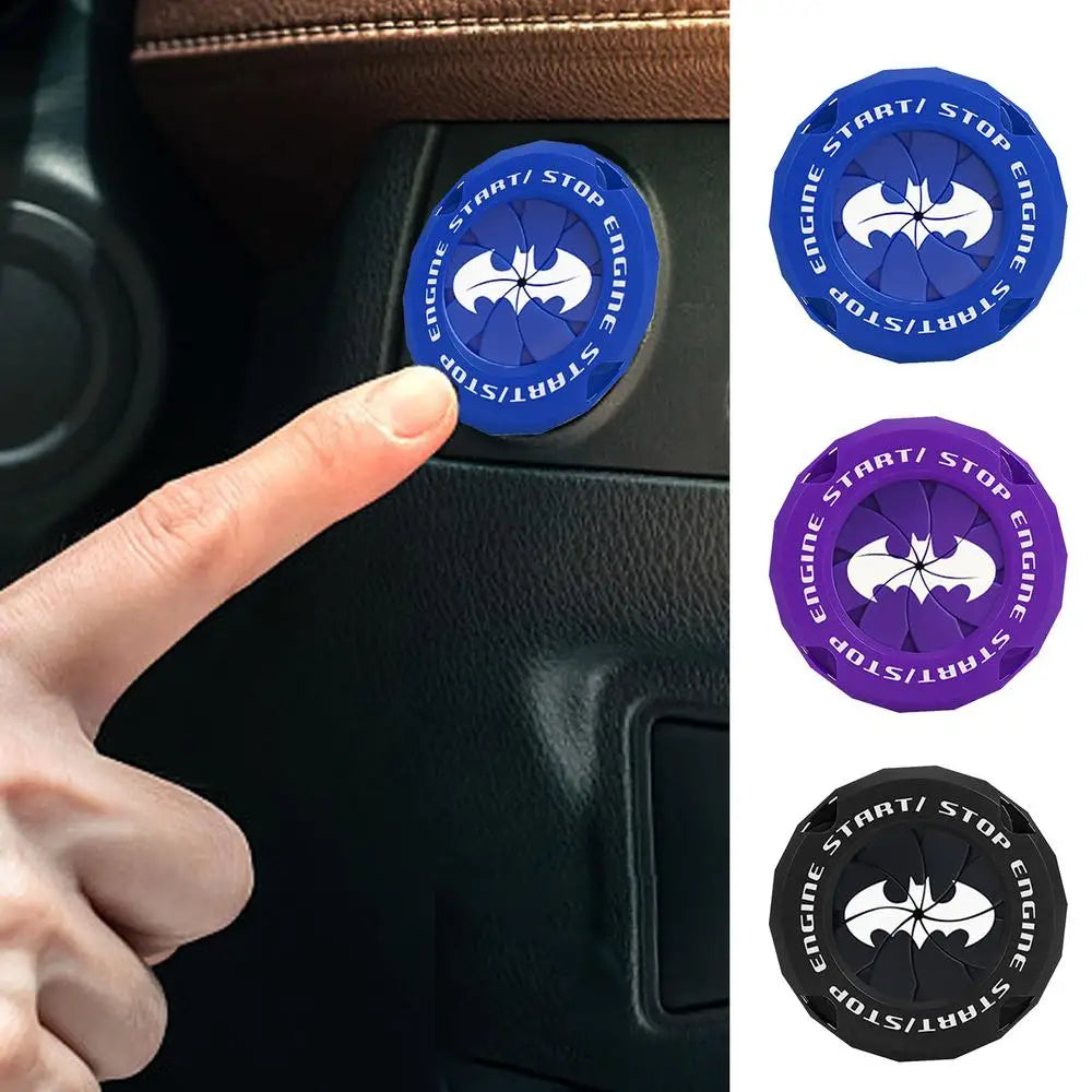 A hand presses a blue push start button cover with a supercar spin design on a car panel.