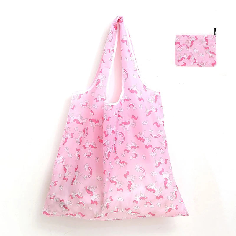 A pink reusable shopping tote bag with a matching pink carry pouch featuring a floral pattern.