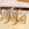 Three small wooden chalkboard signs with curved edges are displayed on a light yellow surface.
