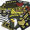 A collection of tactical embroidered military patches featuring various insignia and emblems.