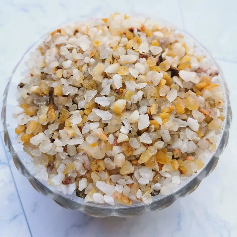 A close-up view of decorative stone pebbles in various shades of white, yellow, and brown.