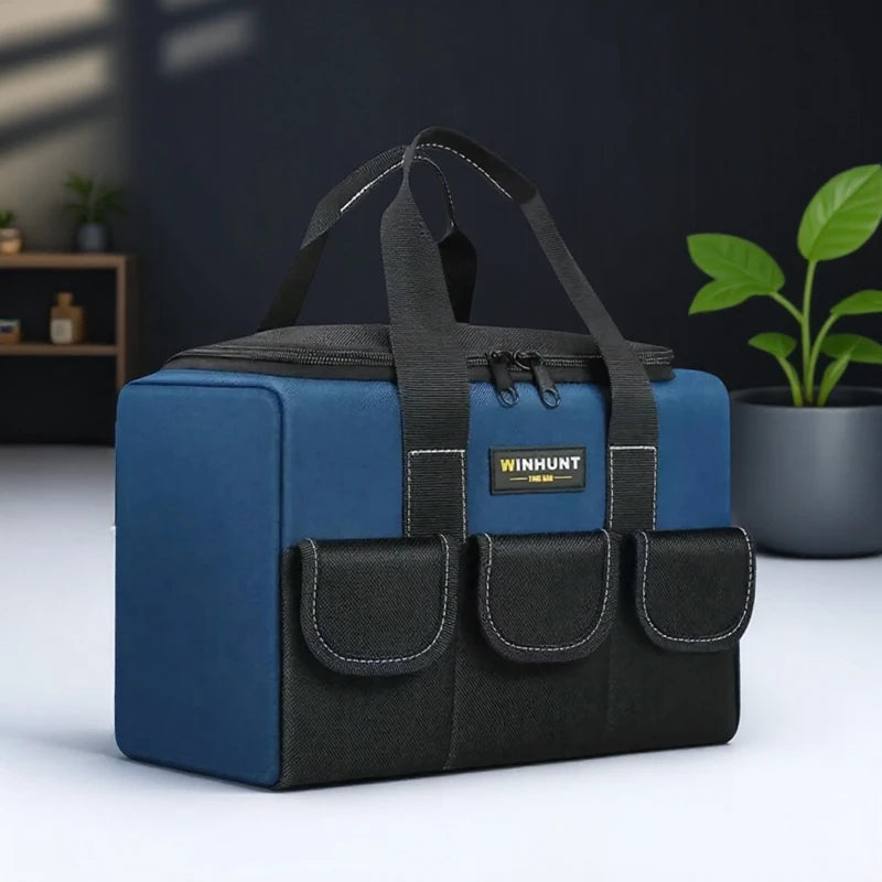 A dark blue heavy duty tool bag with black straps and multiple pockets resting on a white surface.