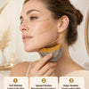 A woman is using a facial massage brush on her face during a gentle upward massage routine.
