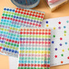 A sheet of colorful glitter star stickers and a notebook page with various star designs.