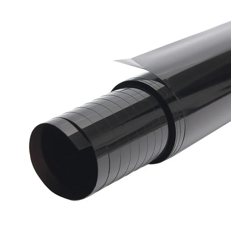A close-up view of a black car window privacy film roll.