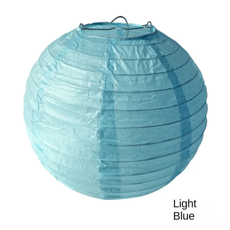 Light blue round paper lantern with a black cord, used for decoration.