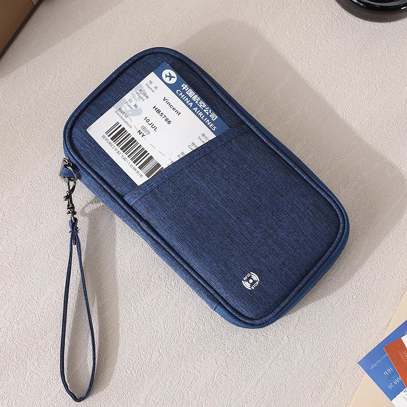 A dark blue RFID-blocking passport holder and travel document organizer with a lanyard, placed on a light surface.
