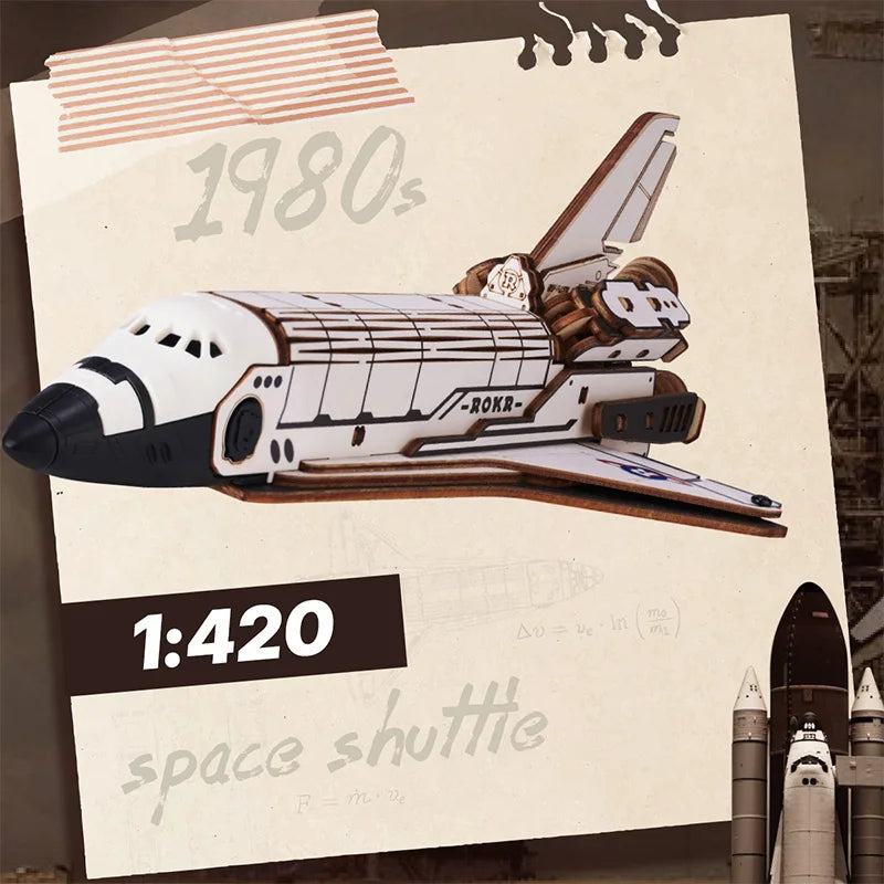 A detailed wooden model kit of a space shuttle, featuring a launch simulator setup.