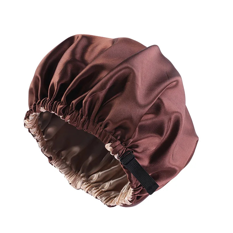 A brown satin sleep bonnet with a gathered top and elasticized edge.
