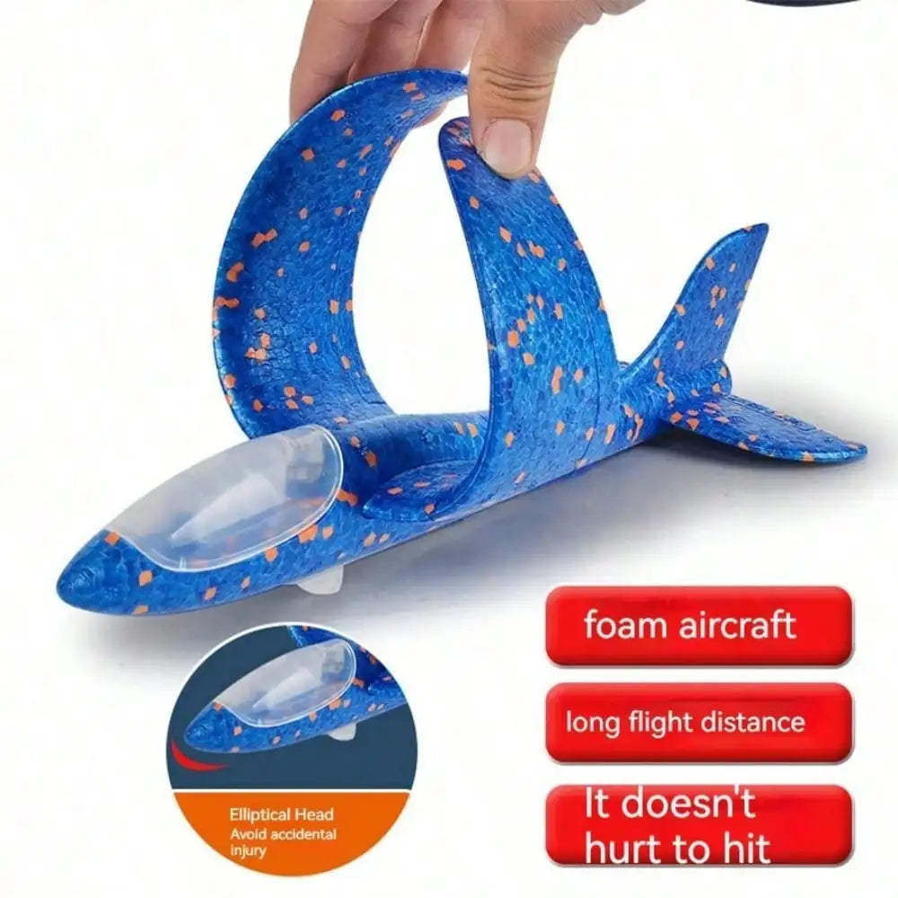 A hand holds a blue foam aircraft glider plane designed for outdoor flying play.