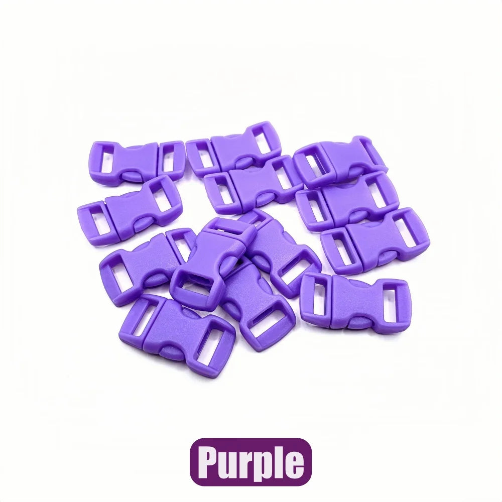 A pile of purple plastic side-release buckles for paracord bracelet projects.