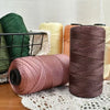Spools of pink and brown ice silk crochet yarn for knitting and DIY crafts