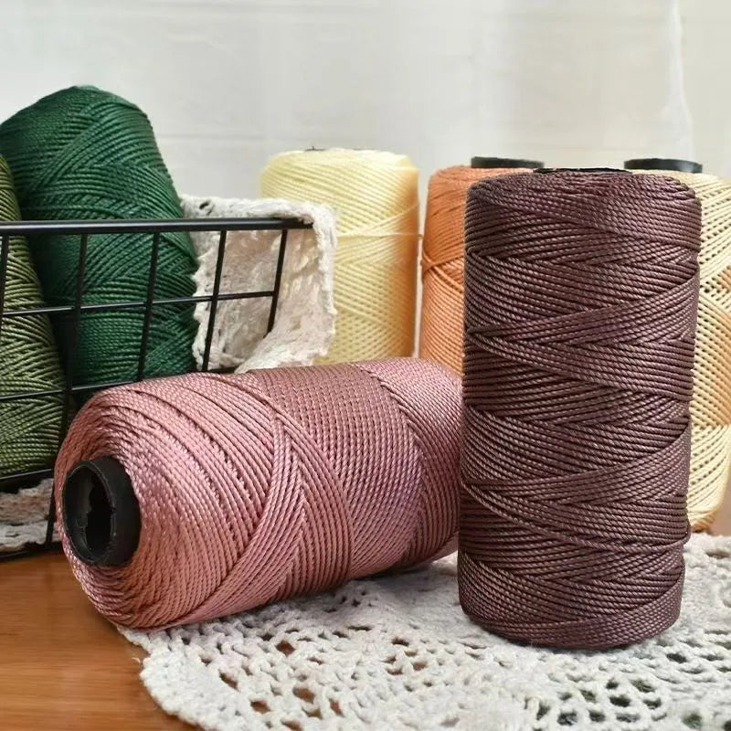 Spools of pink and brown ice silk crochet yarn for knitting and DIY crafts