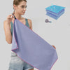 A purple microfiber sports towel is shown being held by a woman against a light gray background.