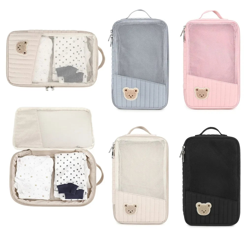 A collection of pastel and dark colored stroller hanging diaper bags with various storage compartments.