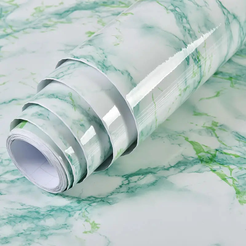 Roll of waterproof self-adhesive marble wallpaper featuring green veining on a white background.