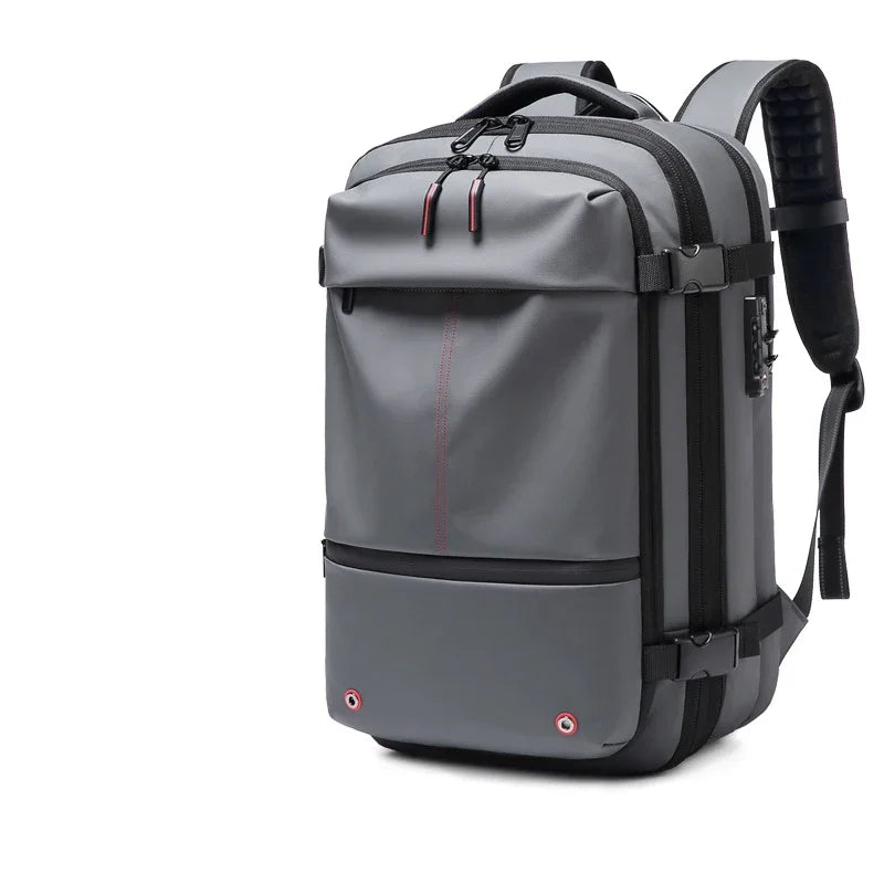 A gray expandable travel laptop backpack with black straps and compression features.