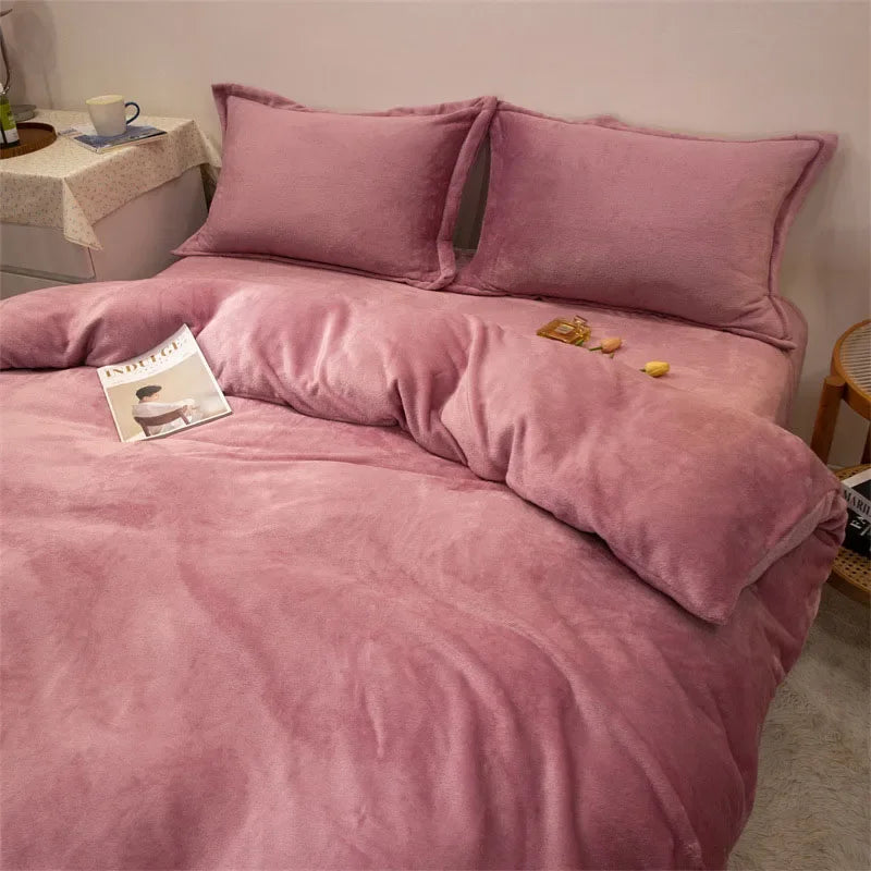 A pink flannel duvet cover with matching pillows and a zipper visible on a bed.