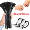 A hand holds a bundle of black heavy-duty self-locking nylon cable ties with individual ties displayed below.