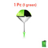 One green parachute toy with a black canopy and a small green figure underneath.