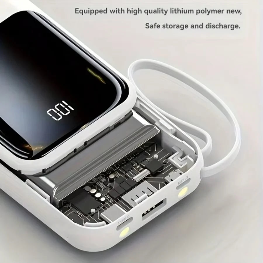 A white portable power bank is shown open, revealing internal components and a charging cable.
