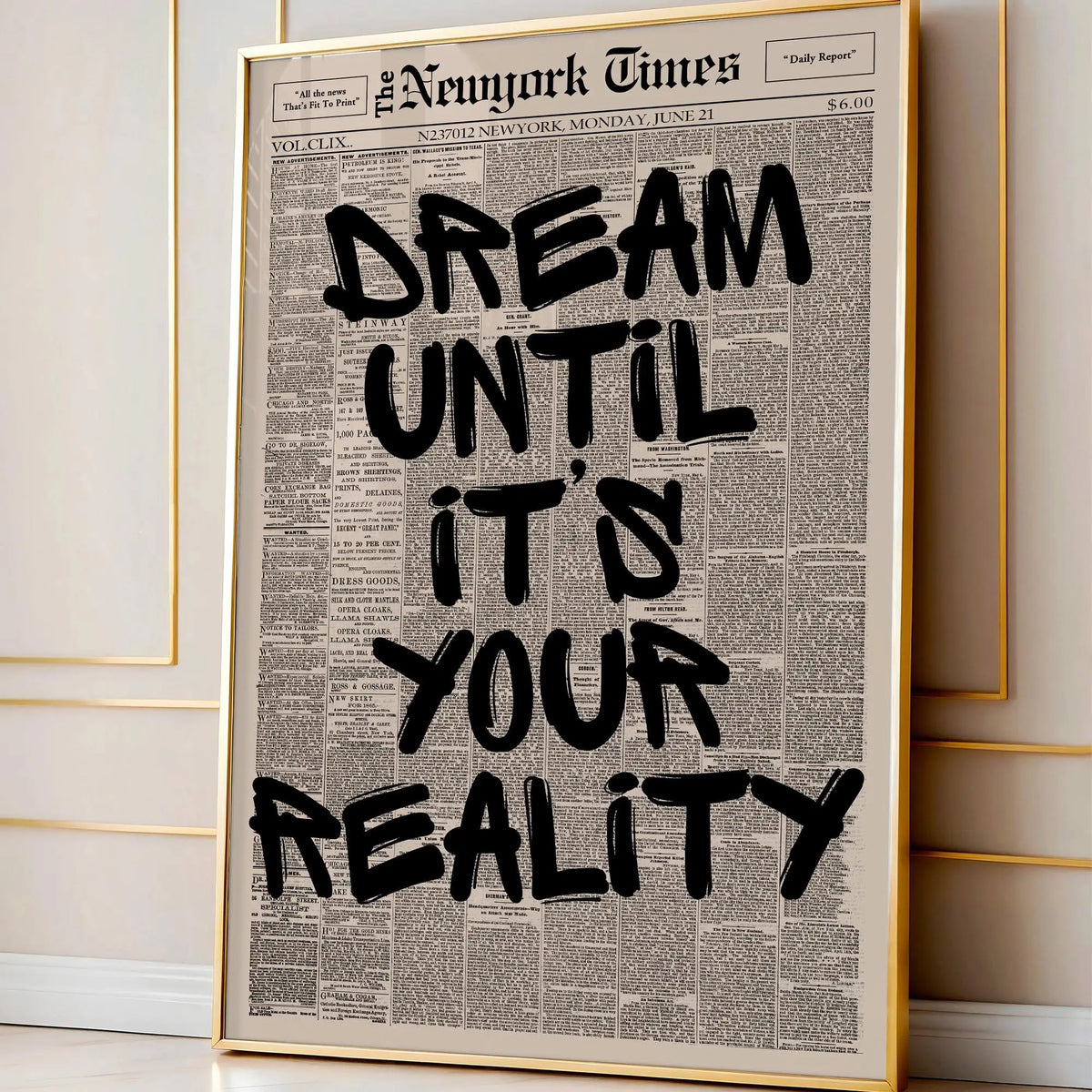 Framed canvas wall art featuring a vintage newspaper style quote that reads Dream Until It's Your Reality