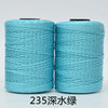 Two spools of teal blue 3-ply polyester knitting yarn for crochet and hand crafts