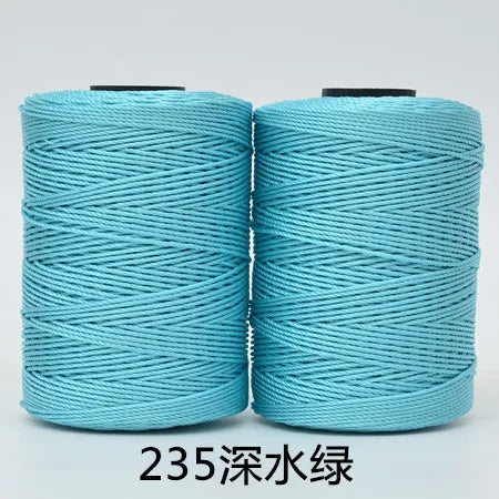 Two spools of teal blue 3-ply polyester knitting yarn for crochet and hand crafts