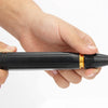 A hand holds a black and gold adjustable high-pressure car wash water gun.