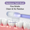 A fine bristle Deciduous Tooth Brush is shown cleaning teeth on a model set of white teeth.
