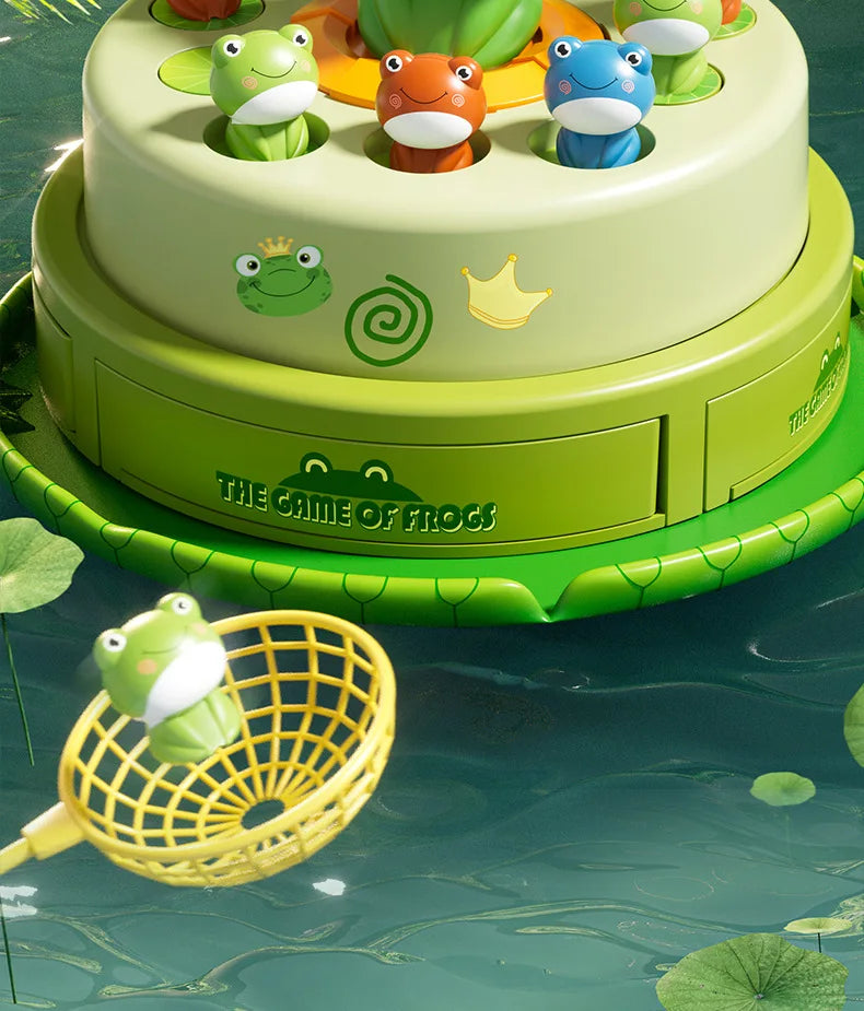 A tiered cake decorated with frog figures, set against a green background, with a yellow fishing net in the foreground.