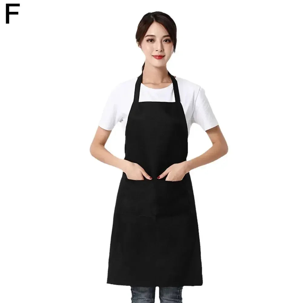 A woman wearing a black adjustable waterproof apron over a white shirt.