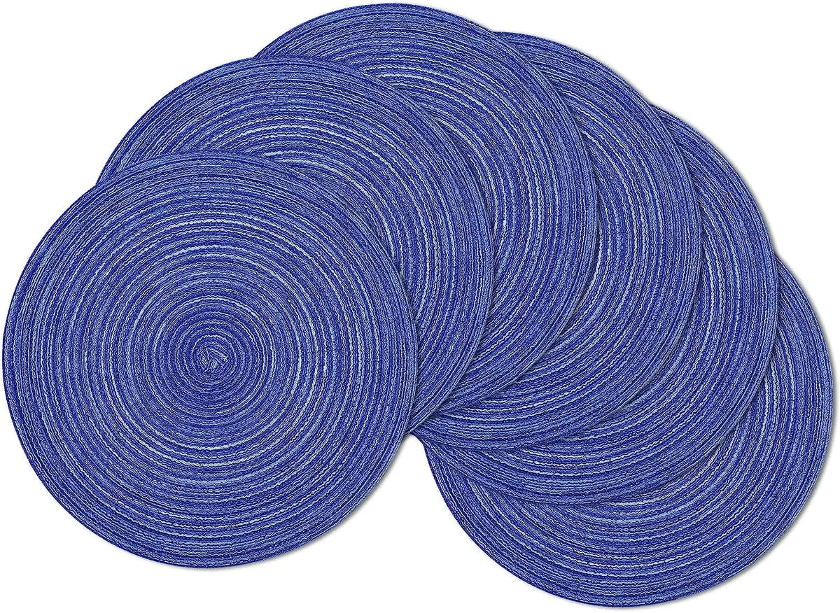 A set of six blue braided round placemats stacked and laid out.
