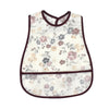 White baby feeding bib with floral pattern and a catch pocket